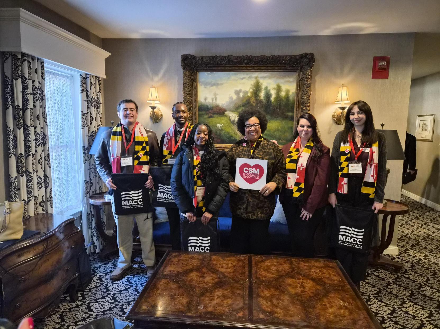 Students stand with CSM President Dr. Yolanda Wilson holding a 'CSM Love' sign