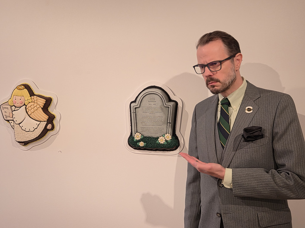Artist Andrew stands next to final piece in showcase