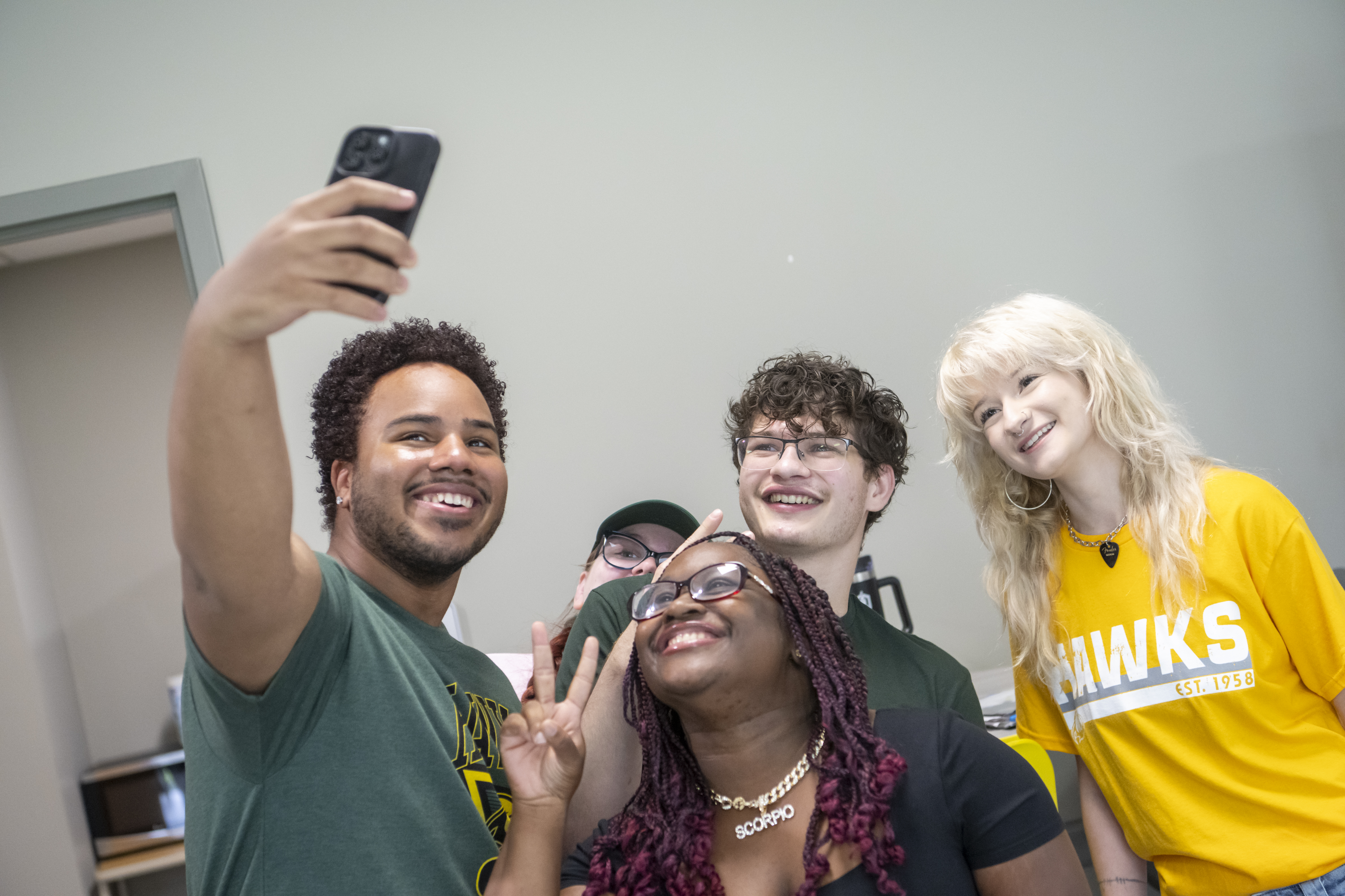 Students pose smiling for a selfie