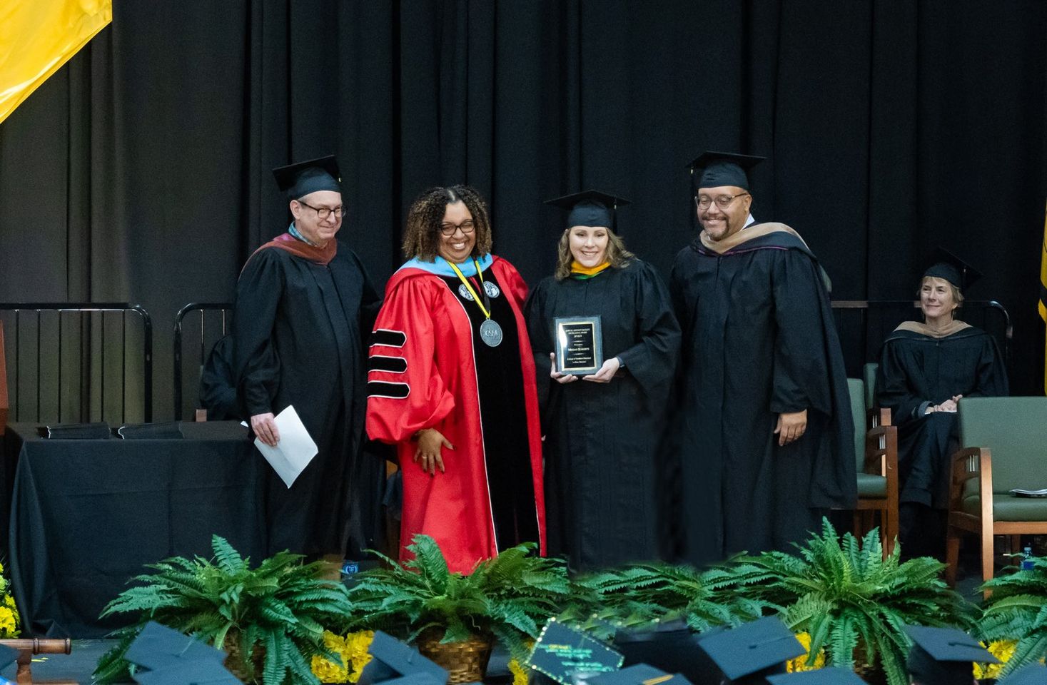 woman on stage receiving award 