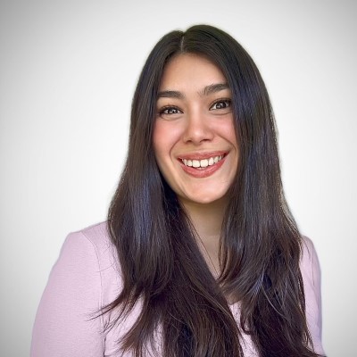 Professional headshot of CSM graduate and current University of Michigan doctoral student Briana Garcia. She has long, dark hair, is wearing a light pink shirt, and is smiling at the camera.