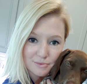 young woman holding puppy