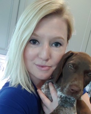 A selfie of CSM grad Brooke Brown and a small dog