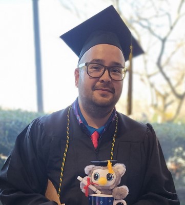 CSM alum Bryan Gomez dressed in graduation regalia