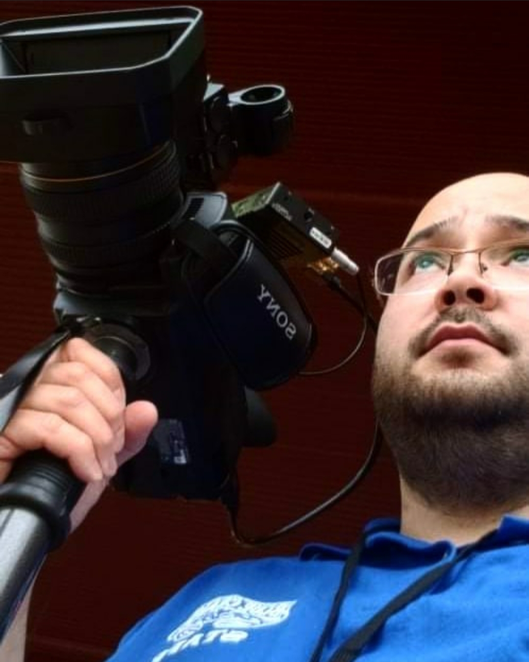 CSM student Bryan Gomez with video camera on his shoulder