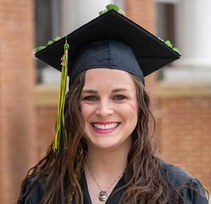 woman smiling in cap and gown