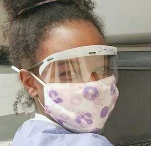 young african american female in lab coat and safety glasses
