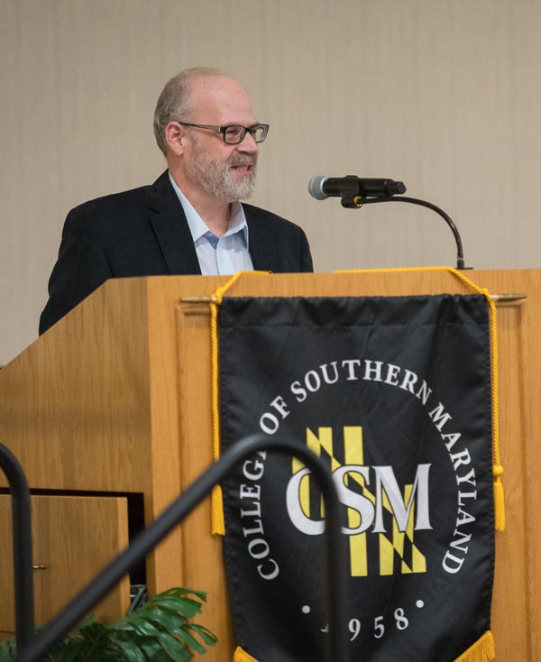 Man speaks at a podium