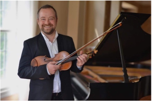 man poses with his violin