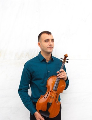 man poses with his violin