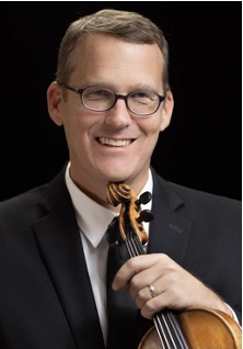 man poses with his violin