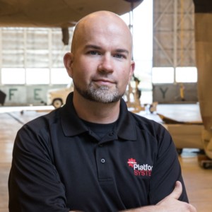 Headshot of CSM instructor Brian Read, standing in an airplane hangar