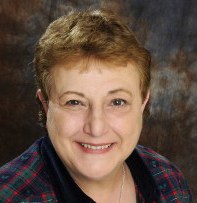 Headshot of a smiling female with short brown hair