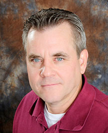 headshot of smiling man