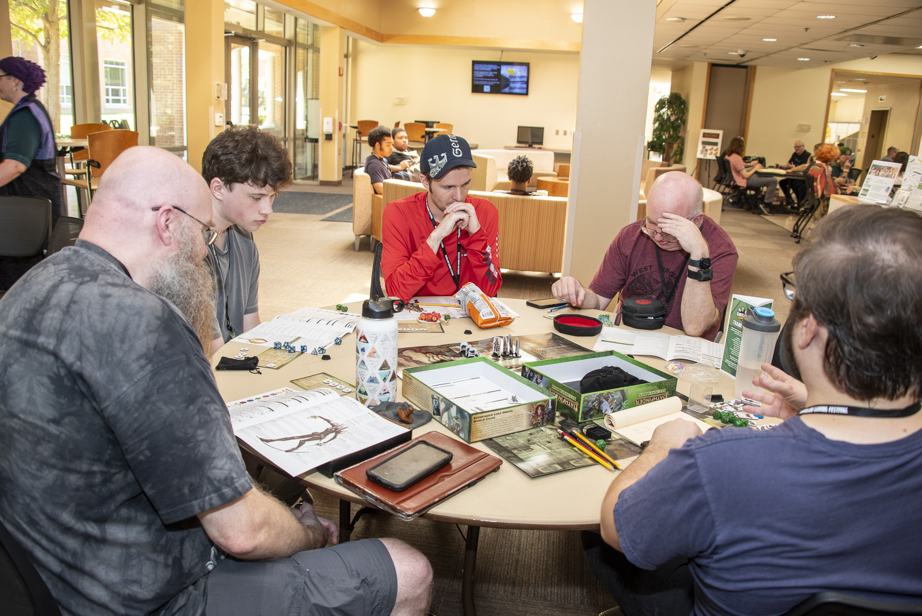 People sit around a table playing a game