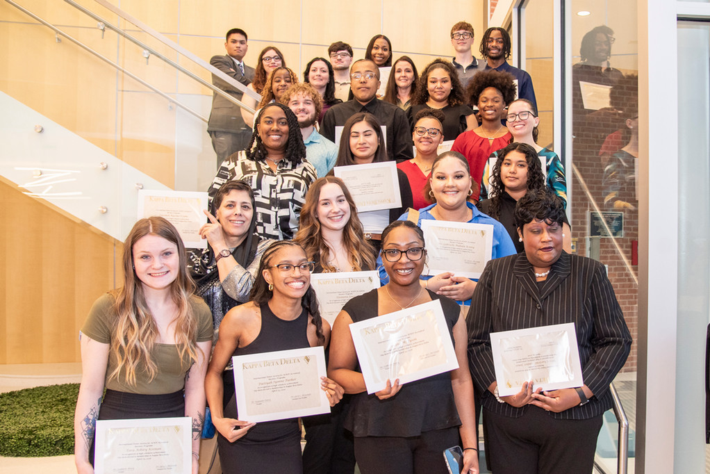 inductees pose on the stairwell