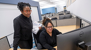 two women in front of computer