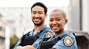 male and female police officers smiling