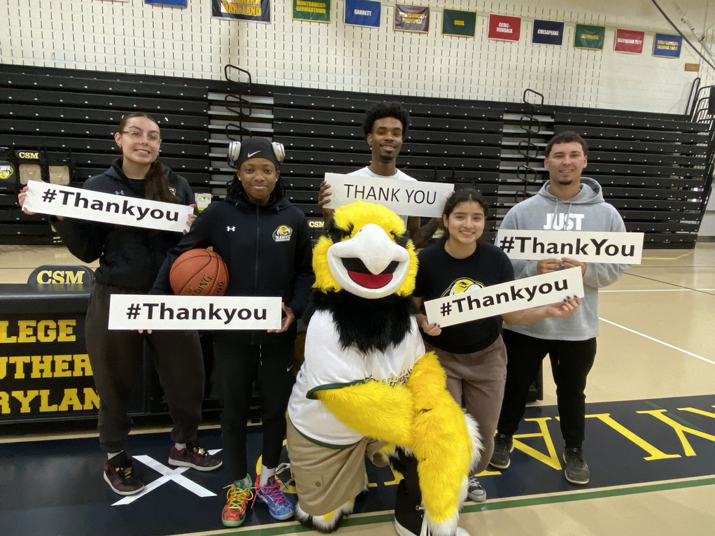 Students holding signs