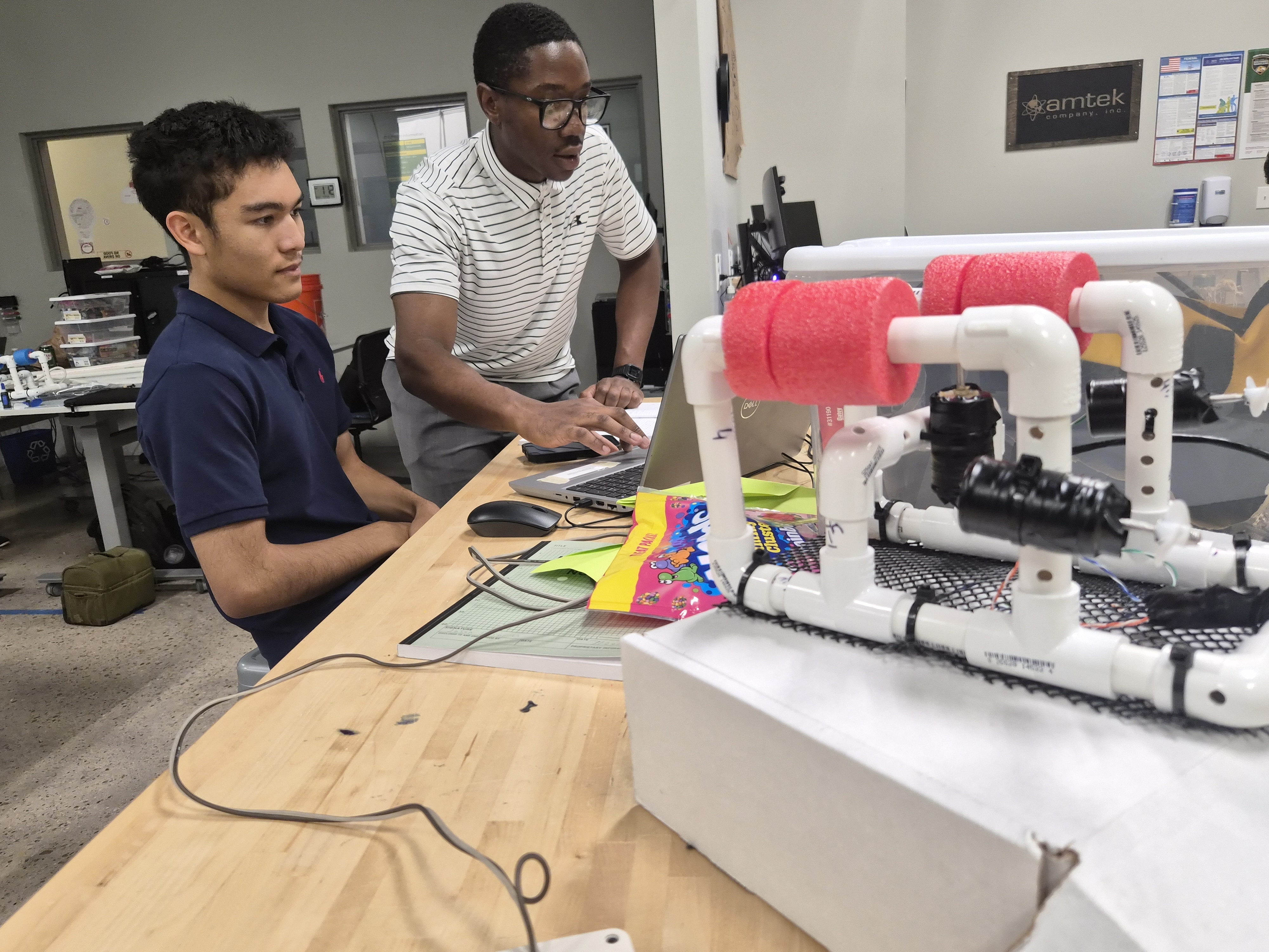 Nathan Ihama helps summer course student with robot project
