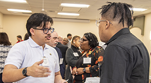 two men talking at a network summit