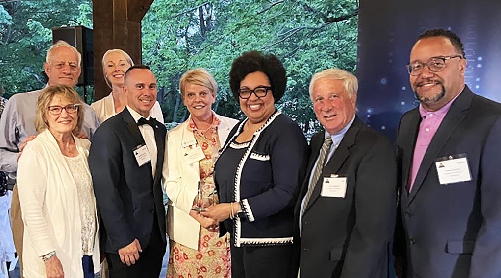 college president and members accepting an award