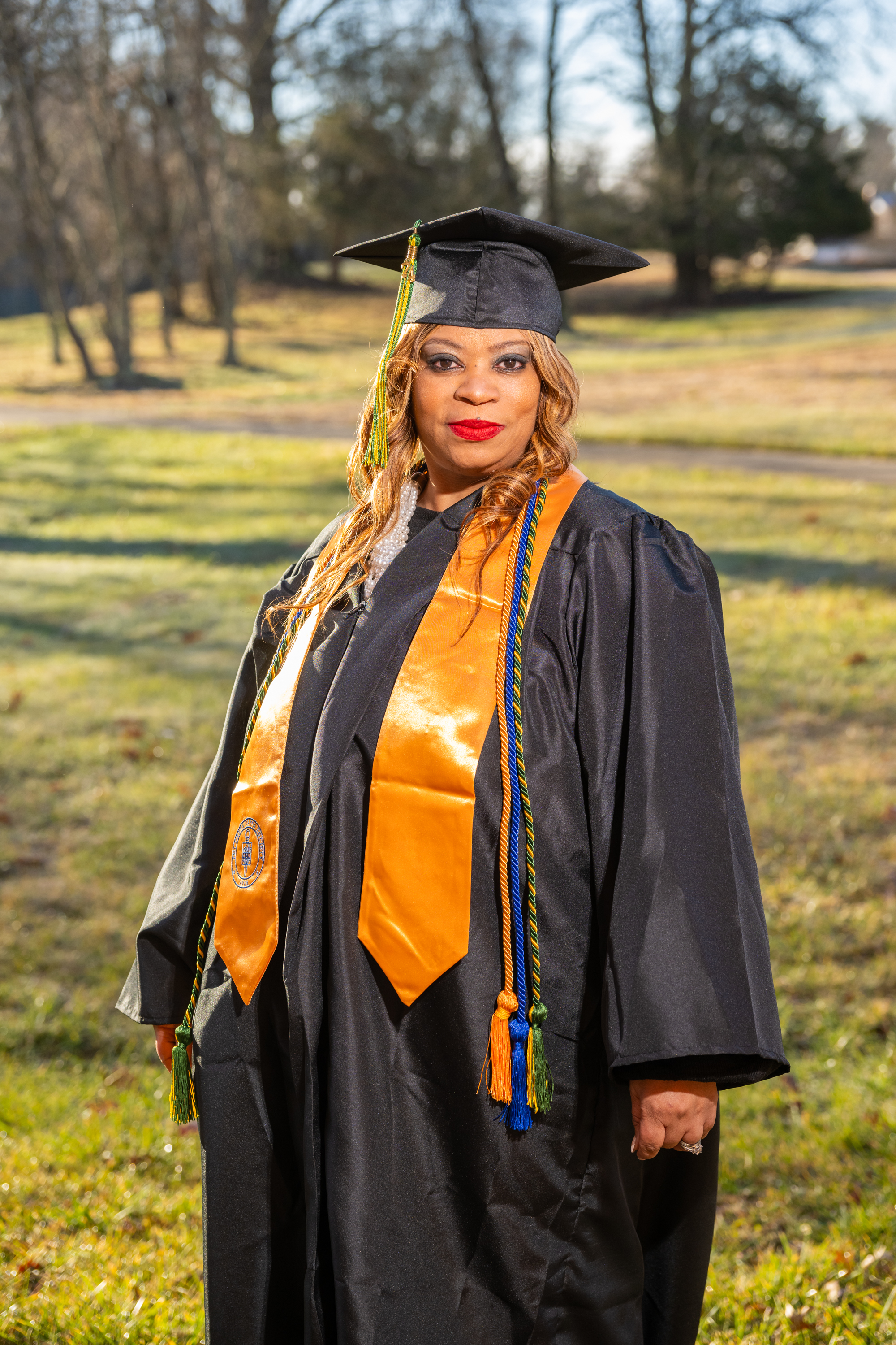 Woman smiles in her cap and gown