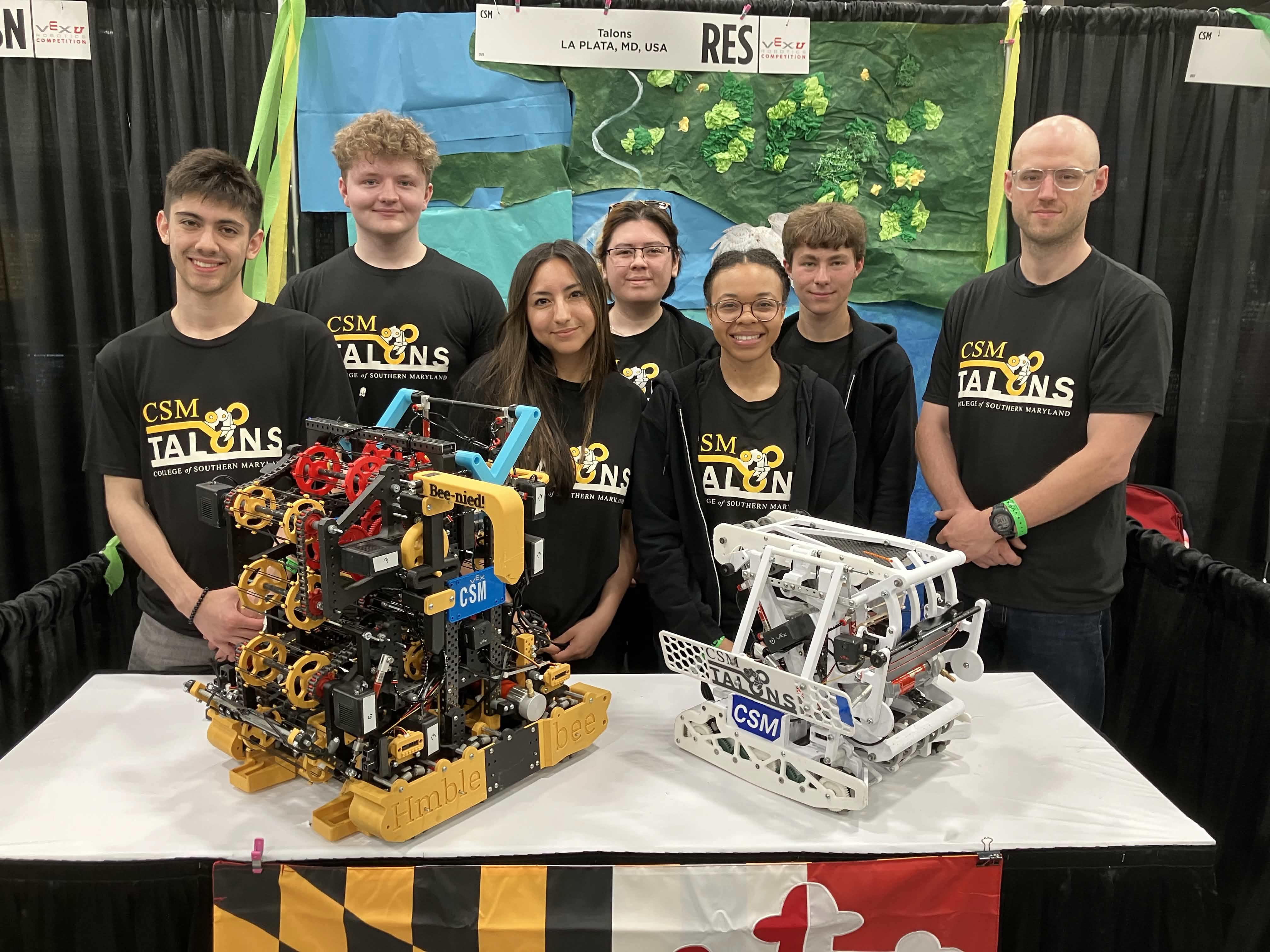Talons team members stand in front of their competing robot