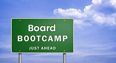 "Board Bootcamp Just Ahead" sign against a blue sky with clouds