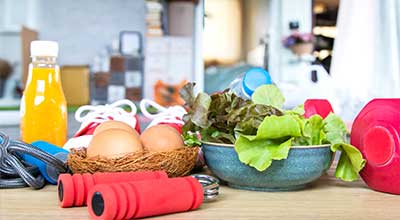 Wellness items, such as juice veggies, a hand strengthening gripper, shoes and a dumbbell